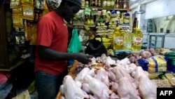 Un vendeur de poulets prépare des oiseaux à vendre sur un marché de Bambilors à Dakar, le 4 mai 2018.