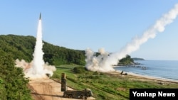 북한의 대륙간탄도미사일(ICBM) 도발에 대응해 5일 오전 한국 동해안에서 열린 미한 연합 탄도미사일 타격훈련에서 한국군 탄도미사일 현무-2A(왼쪽)와 주한미군 에이태킴스(ATACMS)가 동시 발사되고 있다. 한국 합동참모본부 제공.