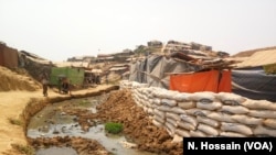 Sandbags have been placed at the edge of a cluster of shacks in Balukhali camp, Cox's Bazar, to prevent the shacks from being washed away during monsoon floods. 