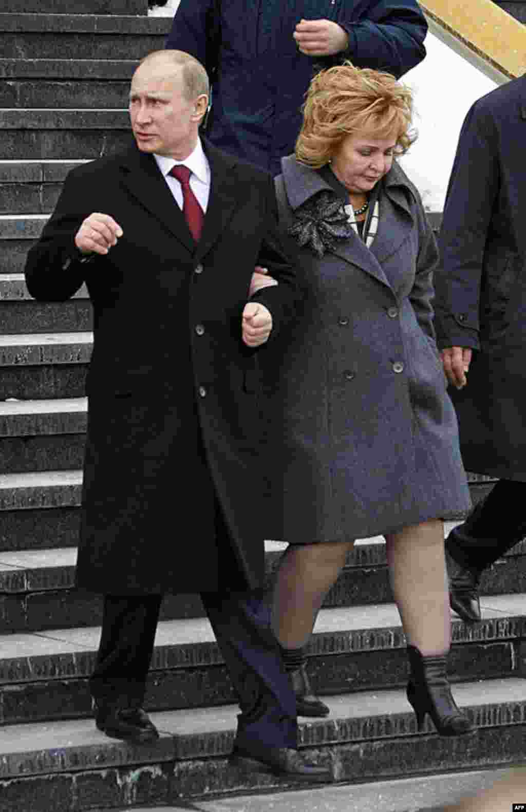 Russian Prime Minister and presidential candidate Vladimir Putin and his wife Lyudmila leave a polling station in Moscow, Russia, March 4, 2012. (AP)