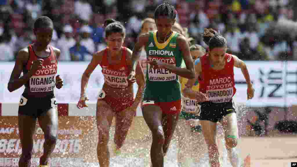 Ethiopia&#39;s Hiwot Ayalew leads the filed through the water jump during heat one of the women&rsquo;s 3000m steeplechase at the World Athletics Championships at the Bird&#39;s Nest stadium in Beijing, Monday, Aug. 24, 2015.