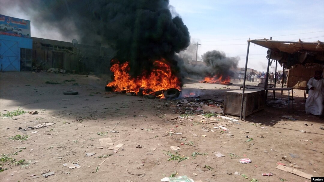 FILE - A bonfire is lit along the street during protests against price increases in Atbara, Nile River state in northeastern Sudan, Dec. 20, 2018.