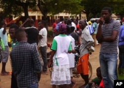 People gather near Friday's train crash in Eseka, Cameroon, Oct. 22, 2016.