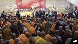 Relatives, religious leaders and government officials attend a memorial for the victims of the collapsed building complex caused by an earthquake in Tainan, Taiwan, Friday, Feb. 12, 2016.