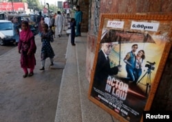FILE - An advertising poster for a Pakistani film with Indian actors is seen outside a movie theater in Karachi, Pakistan, Sept. 30, 2016.