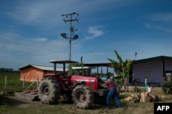 A man prepares a tractor at a farm in San Silvestre, Barinas State, Venezuela, Nov. 28, 2018.