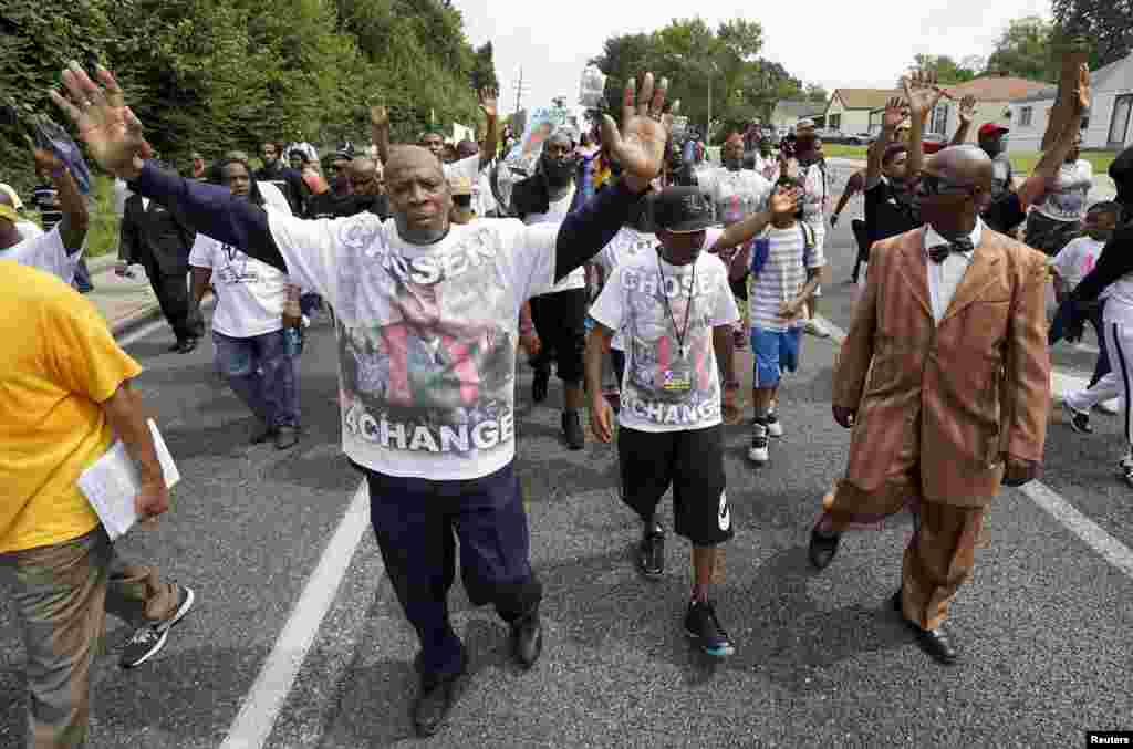 Manifestantes, incluindo Michael Brown Sr. marchando em Ferguson, Missouri, em memória de Michael Brown, 8 de agosto, 2015.