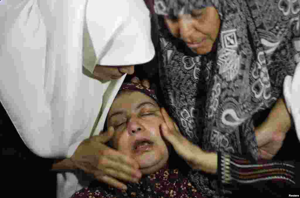 The mother of Ibraheem al-Dawawsa, 10, who was killed in an air strike, is comforted during his funeral in Gaza City, August 8, 2014.