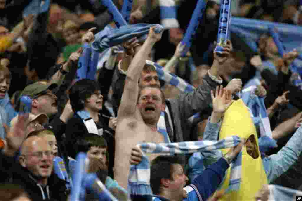 Manchester City fans celebrate victory after the English Premier League soccer match between Manchester City and Manchester United at the Etihad Stadium in Manchester, Monday, April 30, 2012. (AP Photo/Matt Dunham)