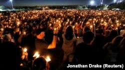 People attend a candlelight vigil the day after a shooting at Marjory Stoneman Douglas High School in Parkland, Florida, U.S., February 15, 2018.