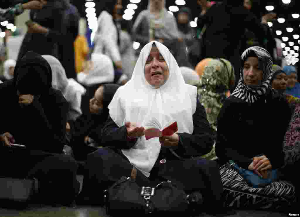 Nahed Ahmed Zeead, 51, of Iraq, takes part in the jenazah, an Islamic funeral prayer, for the late boxing champion Muhammad Ali in Louisville, Kentucky, June 9, 2016.