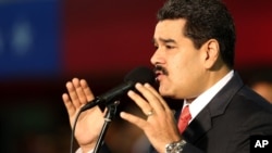 FILE - Venezuela’s President Nicolas Maduro, delivers a speech at the Fort Tiuna military base in Caracas, Oct. 27, 2014.