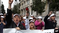 Employees of Greece's health system shout slogans as the banner reads ''Government'' during a protest against government health cuts in Athens, April 17, 2013. 