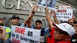 Demonstrators hold signs and a picture supporting Edward Snowden outside the Consulate General of the United States in Hong Kong, June 13, 2013.