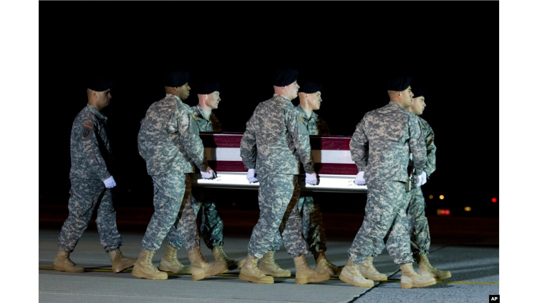 An Army carry team, carries the remains of Army Staff Sgt. Matthew Q. McClintock upon arrival at Dover Air Force Base, Delaware, Jan. 8, 2016.