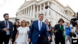 Sen. Jeff Flake, R-Ariz., accompanied by his wife Cheryl, leaves the Capitol in Washington after announcing he won't seek re-election in 2018, Oct. 24, 2017, .