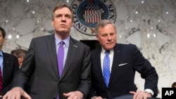 FILE - Senate Intelligence Committee Vice Chairman Mark Warner, D-Va., left, and Sen. Richard Burr, R-N.C., the panel chairman, are pictured prior to a hearing on Capitol Hill in Washington, May 9, 2018.