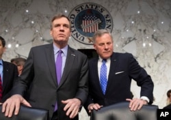 FILE - Senate Intelligence Committee Vice Chairman Mark Warner, D-Va., left, and Sen. Richard Burr, R-N.C., the panel chairman, are pictured prior to a hearing on Capitol Hill in Washington, May 9, 2018.