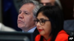 Secretary General of the Organization of American States Luis Almagro, left, listens to Venezuela's Foreign Minister Delcy Rodriguez as she speaks to the Permanent Council of the Organization of American States in Washington, March 27, 2017.