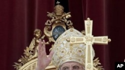 Pope Benedict XVI delivers his blessing during the 'Urbi et Orbi' (Latin for to the City and to the World) message from the balcony of St. Peter's Basilica, Vatican, April 24, 2011
