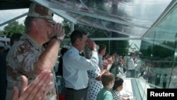 FILE - General Norman Schwarzkopf and U.S. President George H.W. Bush salute troops passing the presidential reviewing stand during Desert Storm Victory parade in Washington, June 8, 1991. The parade was held after the war against Iraq. 