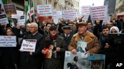 Syrians, including prominent opposition figures, protesting attacks on rebel-held suburb of eastern Ghouta in Syria's capital Damascus, gather during a rally outside the Russian Consulate in Istanbul, Thursday, Feb. 22, 2018. 