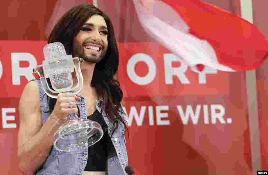 Austria&#39;s Conchita Wurst poses with her trophy before a news conference in Vienna. Wurst, popularly known as &quot;the bearded lady,&quot; won the 59th annual Eurovision Song Contest with the James Bond-theme-like ballad &quot;Rise Like a Phoenix&quot;, before a global TV audience of about 180 million people in 45 countries.