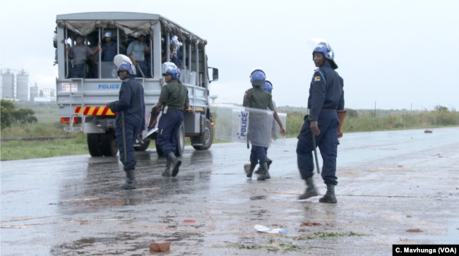 Police are seen deployed in Harare, Jan. 14, 2019, after protesters started blocking roads.