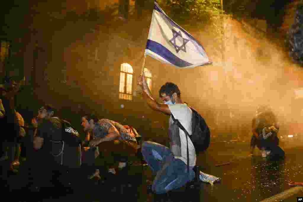 Israeli police use a water cannon to disperse demonstrators during a protest against Prime Minister Benjamin Netanyahu in Jerusalem, July 18, 2020.