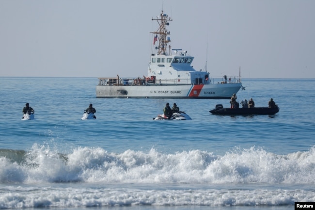 U.S. Border agents and the Coast Guard patrol the Pacific Ocean where the U.S. Mexico border wall enters the water at Border Field State Park in San Diego, California, Nov. 20, 2018.