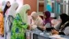 Women line up to vote at a polling station at Penanti in Penang state in northern Malaysia, May 5, 2013. 