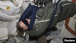 Astronaut Piers Sellers, STS-132 rests in his sleeping bag on the middeck of the space shuttle Atlantis in this photo provided by NASA and taken May 17, 2010.