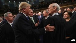 FILE - President Donald Trump greets Supreme Court Associate Justice Stephen Breyer before the State of the Union address in the chamber of the U.S. House of Representatives Tuesday, Jan. 30, 2018, in Washington. 