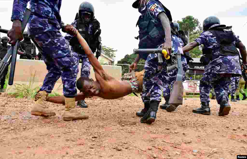 Riot policemen detain a supporter of presidential candidate Robert Kyagulanyi, also known as Bobi Wine, in Luuka district, eastern Uganda.