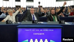 Members of the European Parliament vote in favor of the Paris climate change agreement during a voting session at the European Parliament in Strasbourg, Oct. 4, 2016.