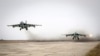 FILE - Sukhoi Su-25 jet fighters take off during a drill at the Russian southern Stavropol region, March 12, 2015. 