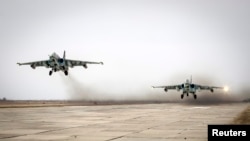 FILE - Sukhoi Su-25 jet fighters take off during a drill at the Russian southern Stavropol region, March 12, 2015. 