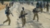 Sudan People's Liberation Army (SPLA) soldiers walk along a road in Mathiang near Bor, Jan. 31, 2014. 