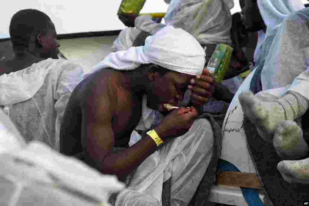 A migrant eats a hot meal as they rest aboard the Aquarius rescue ship in the Mediterranean, June 25, 2016. More than 600 migrants were rescued by SOS Mediterranee and the medical aid group Medecins Sans Frontieres (MSF).