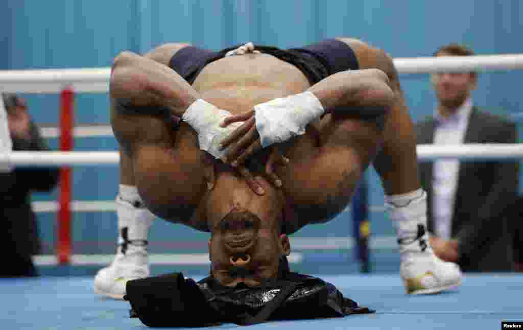 Boxer Anthony Joshua bends over backwards during the media session at the English Institute of Sport in Sheffield, April 19, 2017.