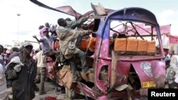 Residents look for survivors in wreckage of passenger mini-bus that was bombed in the Eastleigh suburb of Nairobi, Kenya, Nov. 18, 2012.