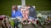 An image and floral tributes for Jo Cox, the 41-year-old British Member of Parliament shot to death yesterday in northern England, lie placed on Parliament Square outside the House of Parliament in London, June 17, 2016. 