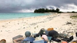 In this Oct. 22, 2019, photo, plastic and other marine debris sits on the beach on Midway Atoll in the Northwestern Hawaiian Islands.