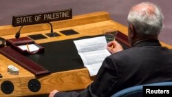 FILE - Palestinian U.N. Ambassador Riyad Mansour reads a statement from the President of the United Nations Security Council during a meeting at the U.N. headquarters in New York.