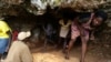 People emerge from a cave in southwest Haiti, where scores continue to seek shelter after their homes were damaged or destroyed by Hurricane Matthew last October. (B. Magloire/ VOA)