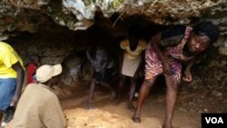 People emerge from a cave in southwest Haiti, where scores continue to seek shelter after their homes were damaged or destroyed by Hurricane Matthew last October. (B. Magloire/ VOA)