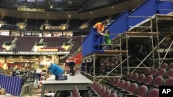 FILE - Workers prepare a camera platform inside Quicken Loans Arena in preparation for the Republican National Convention in Cleveland, June 28, 2016.