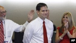 Republican Florida Senator-elect Marco Rubio and his wife Jeanette smile as national TV stations call the race in his favor while watching results in Coral Gables, Florida, 2 Nov. 2010