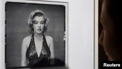 FILE - A visitor looks at the picture 'Marilyn Monroe, Actress, New York City, May 6, 1957' by photographer Richard Avedon (1923-2004).
