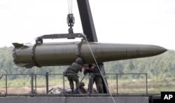 FILE - Russian servicemen equip an Iskander tactical missile system in Kubinka, outside Moscow, Russia, June 17, 2015.